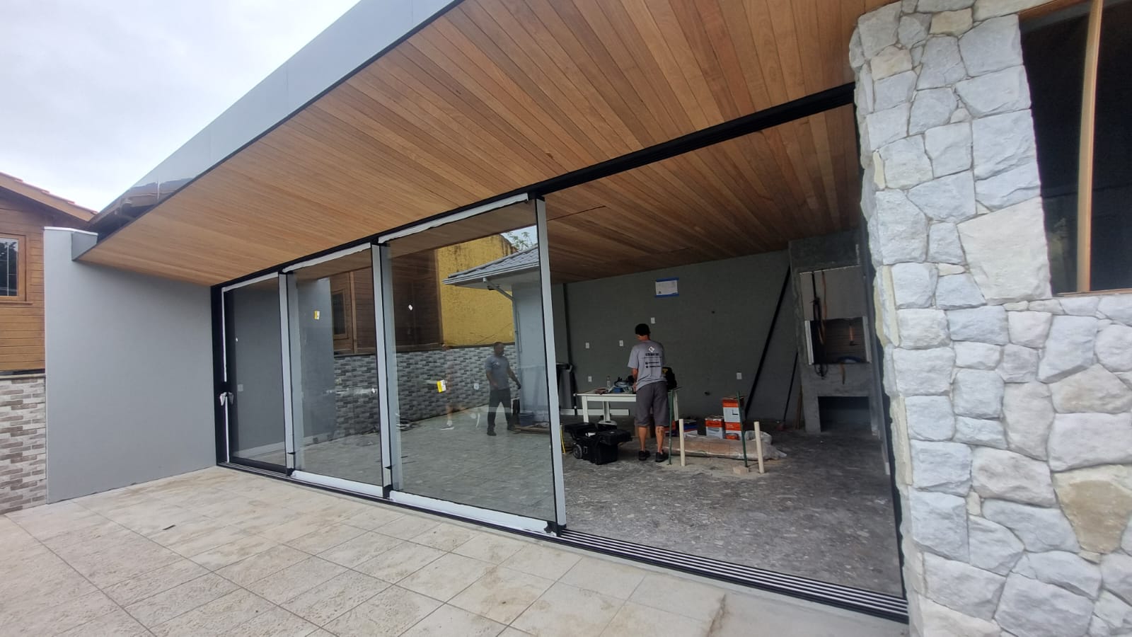Integração Indoor-Outdoor – Portas de correr de grande vão com perfis ultra-finos e acabamento em preto fosco.